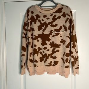 Distressed cow print sweater
